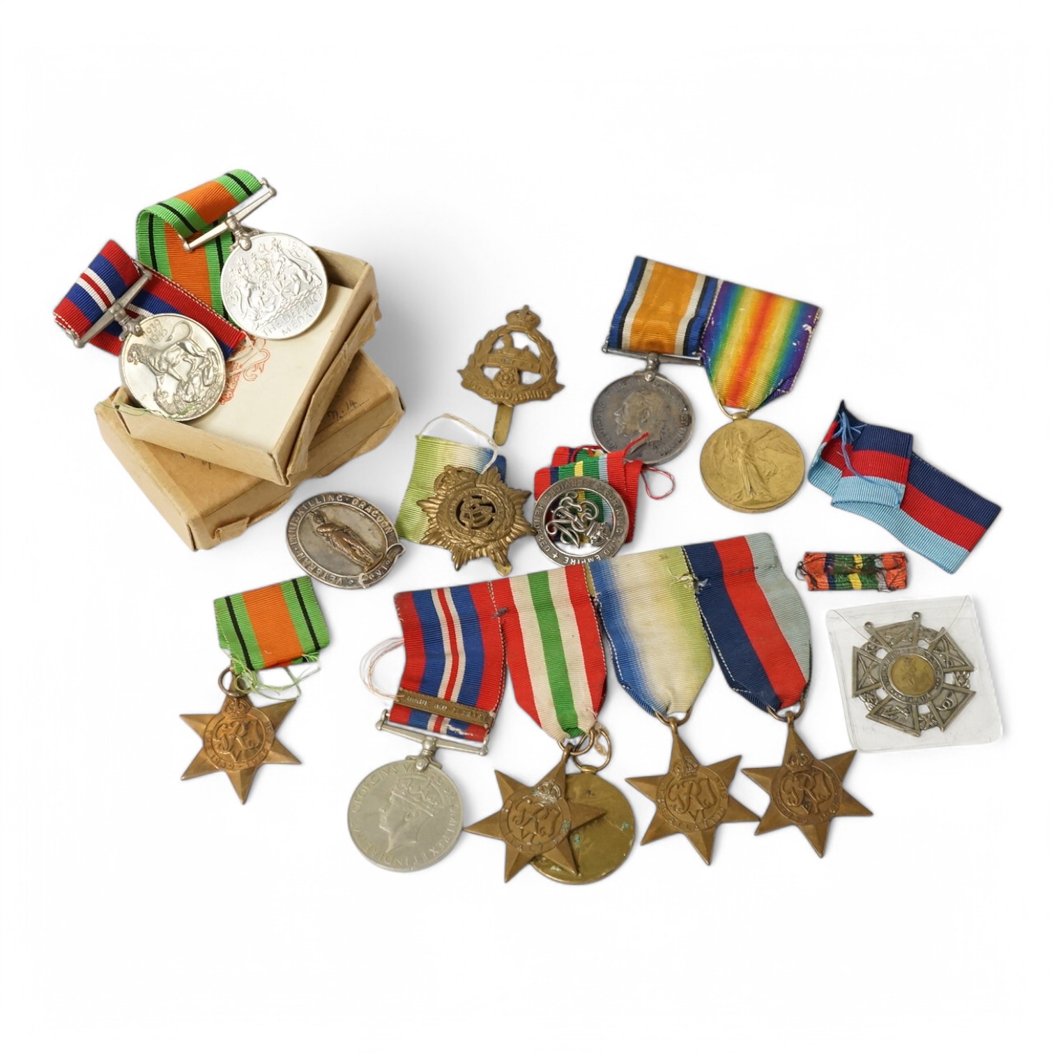 Nine military medals including; a First World War medal pair to T3-026887 DVR. C. Oldfield. A.S.C., a WWII group comprising; The Atlantic Star, The 1939-1945 Star, The Italy Star and The 1939-1945 Medal with a clasp for